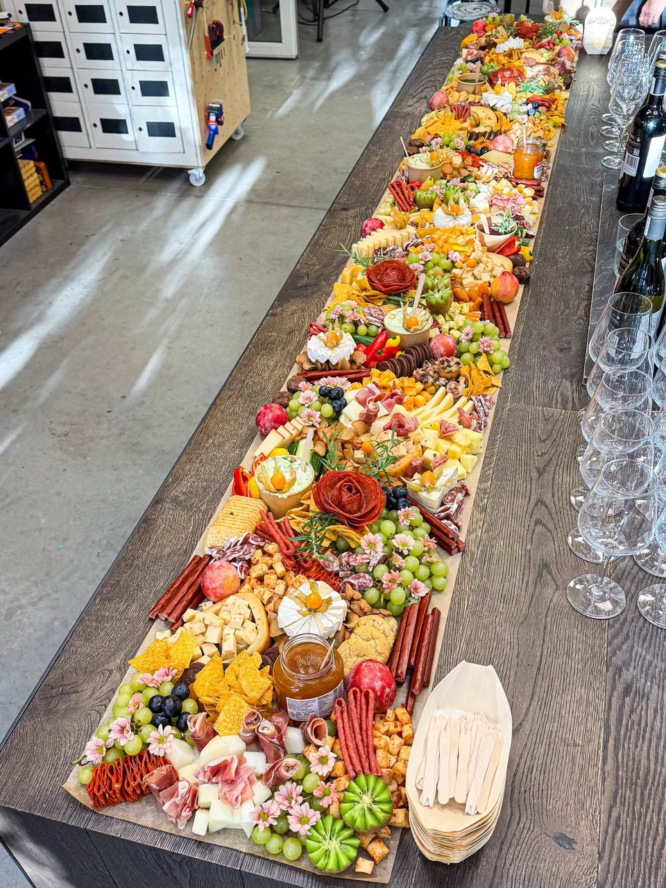 Long grazing table arranged beside an event bar
